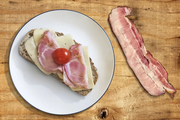 Ham Cheese and Tomato Sandwich with Bacon Rasher on Old Wooden Table Surface — Stock Photo, Image