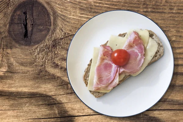 Formaggio di prosciutto e pomodoro Sandwich con pancetta Rasher sulla vecchia superficie di legno — Foto Stock