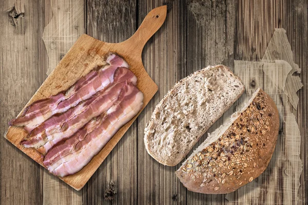 Integral Bread and Cutting Board with Bacon Rashers on Old Wooden Background — стокове фото