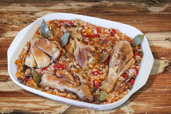 Cicken Meat with Vegetable Stew in Porcelain Pan Isolated on Old Wooden Table