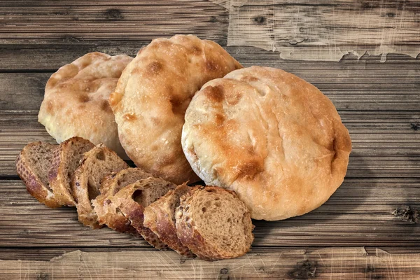 Rebanadas integrales de pan de baguette con pan de pita en una mesa de madera vieja —  Fotos de Stock