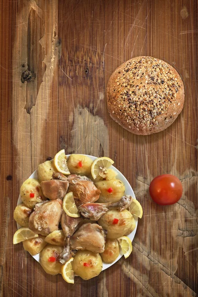 Plate of Fried Chicken Legs with Potato Slices Integral Bread and Tomato on old Wooden Table — ストック写真