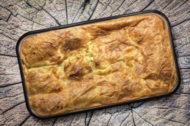 Serbian Traditional Gibanica Cheese Pie Slices on Old Wood Background