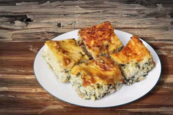 Plate of Serbian Cheese Spinach Pie Zeljanica Slices Set on Old Wood Background — Zdjęcie stockowe