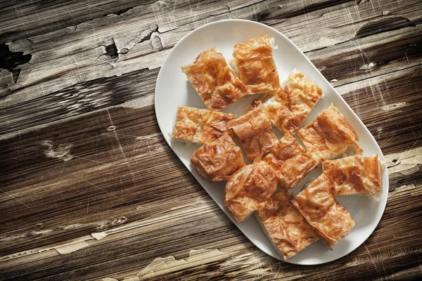 Plateful of Spit Roasted Pork Slices on Old Cracked Peeled Wooden Surface — Stock Photo, Image