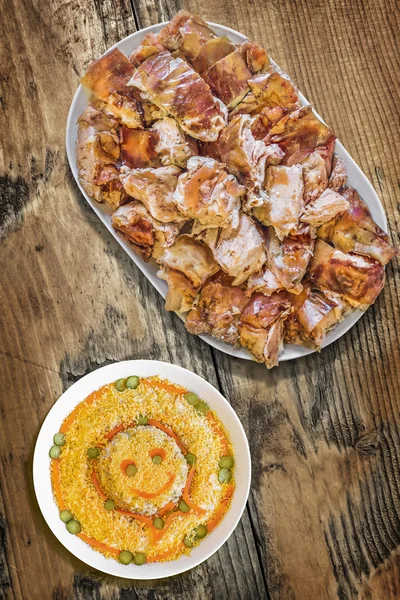 Cerdo asado con ensalada rusa en mesa de madera vieja — Foto de Stock