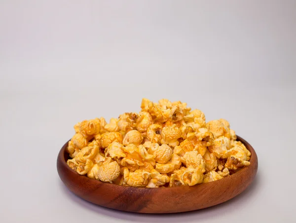 Place the popcorn in a wooden bowl. — Stock Photo, Image