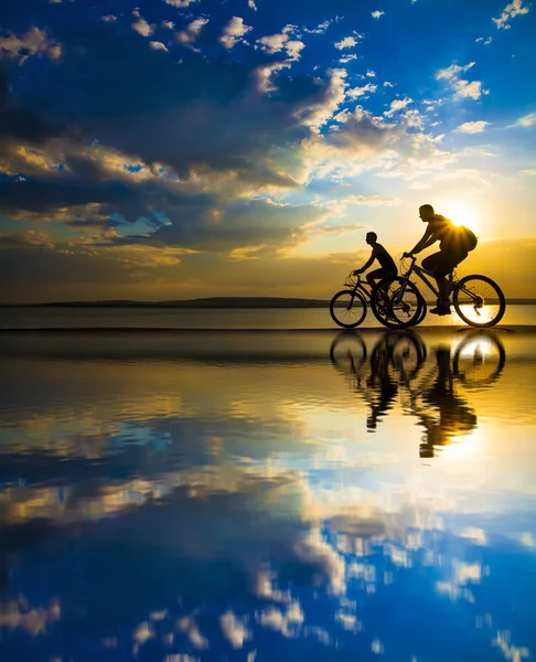 Silhouette di ciclisti sulla costa . — Foto Stock