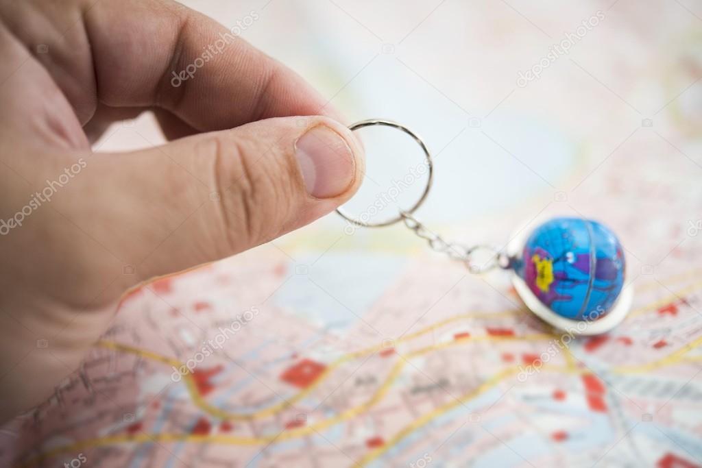 man holding world globe with a chain