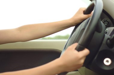 woman's hands driving car