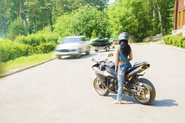 brunette woman sit on sports motorcycle