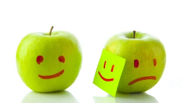 Manzanas con caras sonrientes y lloronas — Foto de Stock