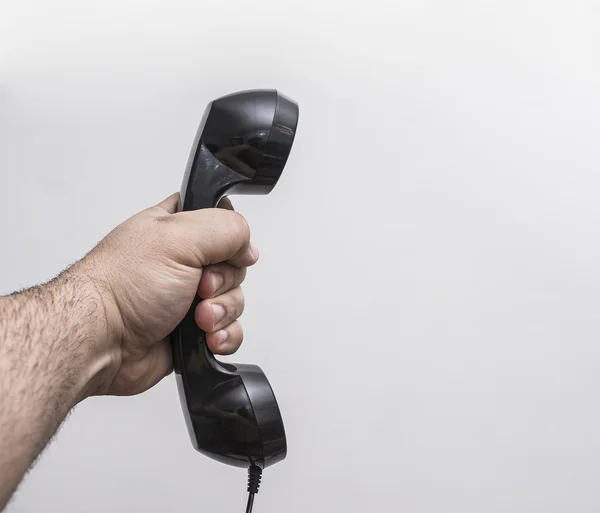 Man Hand with black telephone handset — Stock Photo, Image