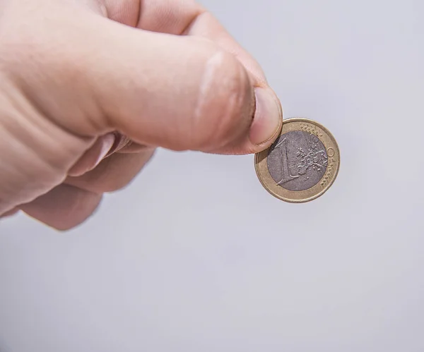 Hand holding one euro coin — Stock Photo, Image