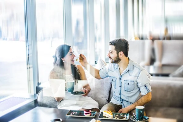 Man feeding a biscuit to his girl friend — Stock Photo, Image
