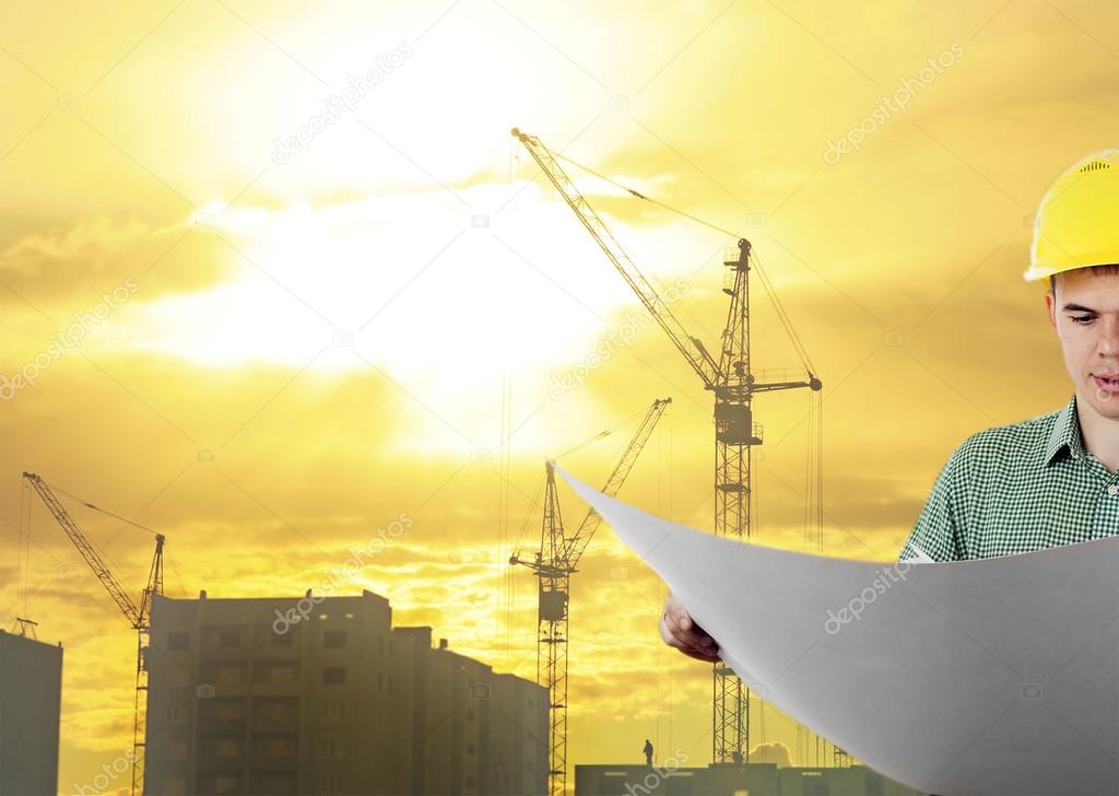 engineer holds blue print 