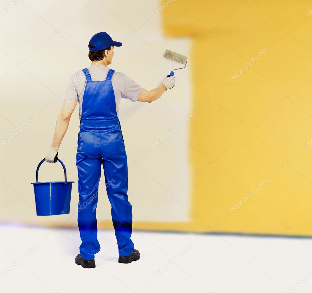 Lift wall painter. покраска стен маляр. белая стена плохо прокрашенная. мужчина у стены. парень красит стену.