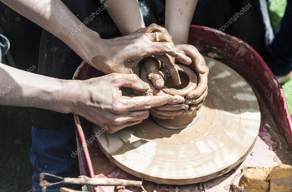 Potter's hands guiding a child hands — Stock Photo © borjomi88 116812942