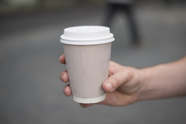 hand holding paper cup