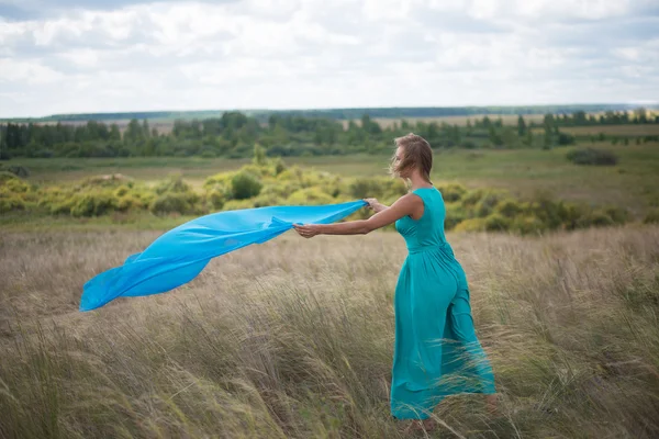 Girl with flying blue cloth — Stock Photo, Image