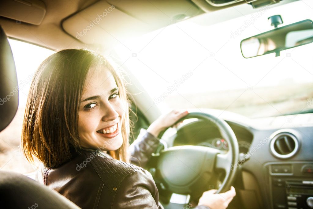 young woman in car  turning