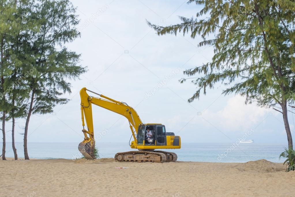 yellow Excavator on tropical beach