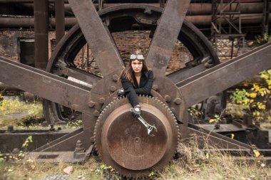 Steam-punk girl fixing  rusty cogwheel or gear  clipart