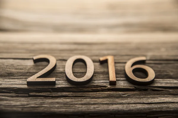 2016 on old wooden texture