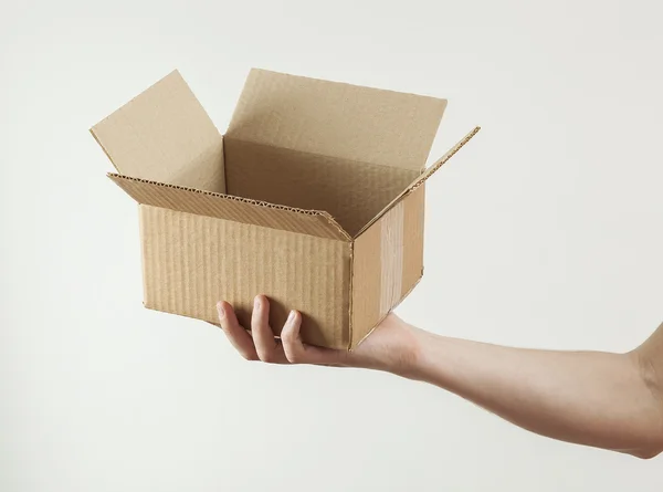 Man 's hand with paper empty box — стоковое фото