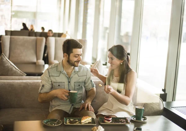 Young couple sitting in cafe — Stock Photo, Image