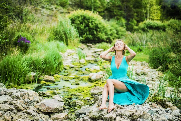 Woman wearing blue dress sitting — Stock Photo, Image