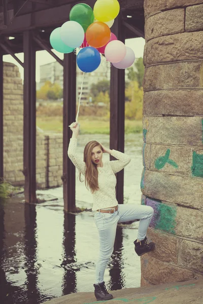 Vintage photo.  Full length portrait  of woman having fun with colorful balloons