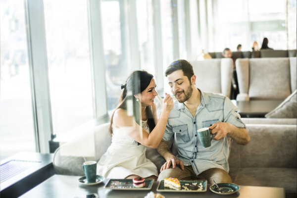 young couple sitting in cafe 