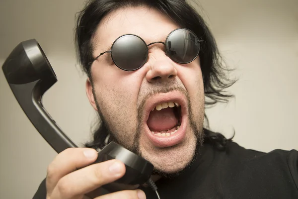 Young brunette man with vintage style handset.