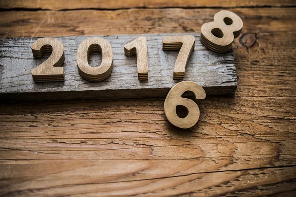 Wooden numbers  on rustic board — Stock Photo, Image