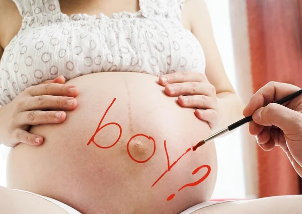 Woman with word boy on tummy — Stock Photo, Image