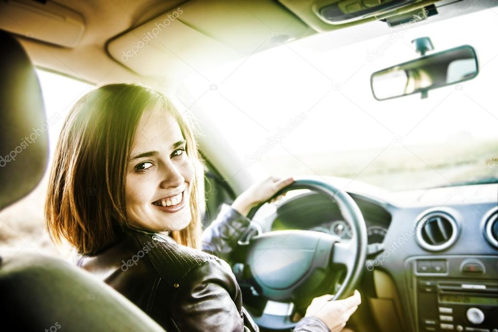 young woman in car  turning