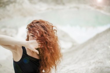 Funny young r girl hiding her face with her hand\
