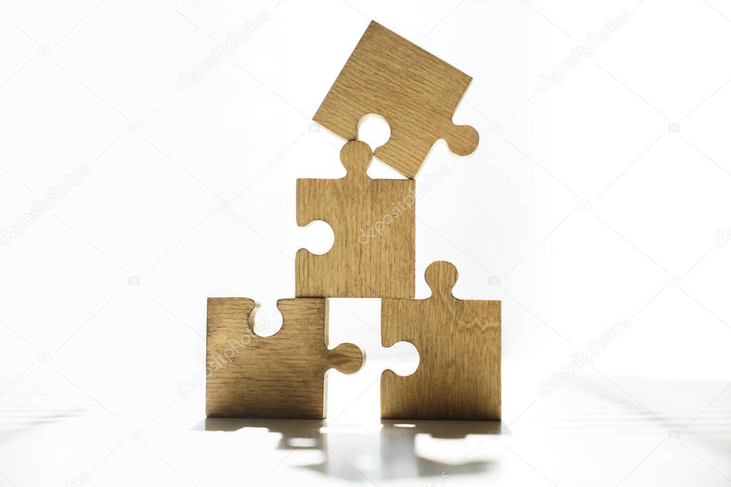 four wooden puzzle pieces. concept of connection people