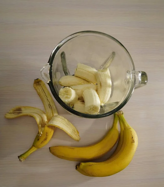 bunch of bananas. blender, smoothie preparation, top view. Concept of fitness healthy eating