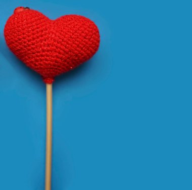 Kırmızı yün kalp mavi arka planda izole edilmiş. Sevgililer günün kutlu olsun..