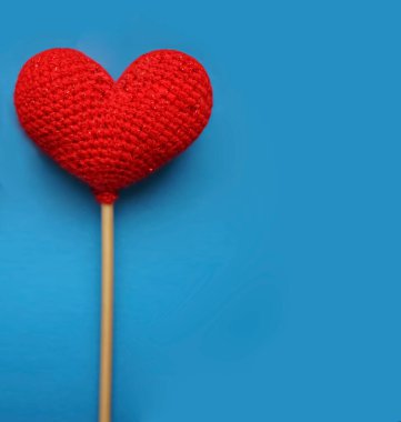 Kırmızı yün kalp mavi arka planda izole edilmiş. Sevgililer günün kutlu olsun..