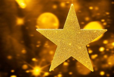 Altın parıldayan yıldız şeklindeki Noel süsü izole edilmiş, yuvarlak oyuncaklar. Mutlu yıllar ve mutlu Noeller..