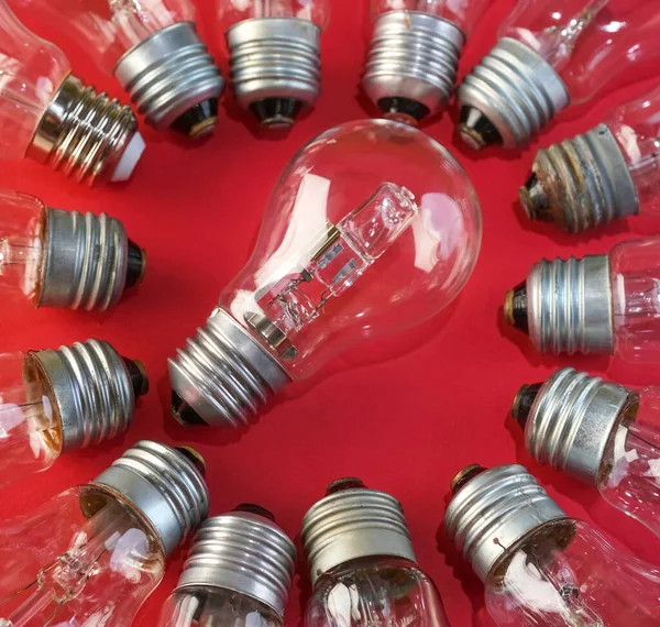 tungsten filament lamp and many lamp bulbs around. brainstorming idea.