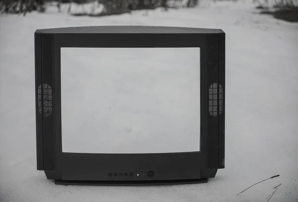 旧的无用的电视概念 在没有电力供应的雪地里废弃的破碎的复古电视机 空屏幕 技术概念 — 图库照片