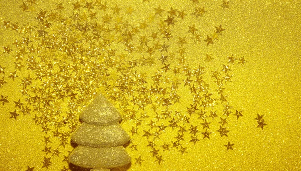 Christmas tree made of  stars glitter confetti  holiday backdrop. Greeting card. View from above, flat lay style. empty copy Space for text.