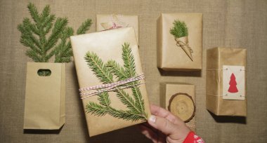 Çam dalları, hediye kutuları, çuval bezi arka planda. Mesaj için yer var. Üst Manzara. Düz yatıyordu. 2021 mutlu yıllar. Noel kompozisyonu