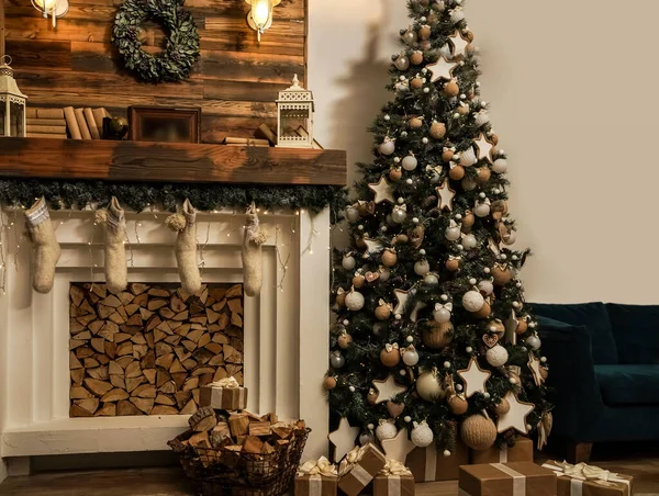 Interior eco style.decorated interior of couch and Christmas tree, modern and cozy. happy new year and merry christmas. Design room with Christmas tree, sofa and the fireplace.