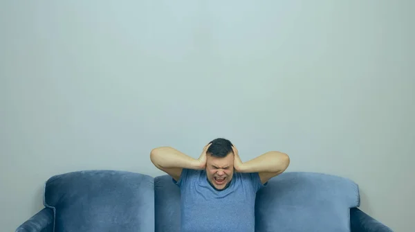 Hombre Sentado Sofá Delante Hombre Habitación Cubriendo Las Orejas Con —  Fotos de Stock