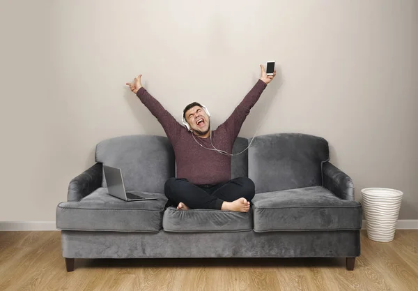 Hombre Escuchando Música Auriculares Emocionado Cantar Canción Sofá Con Ordenador — Foto de Stock